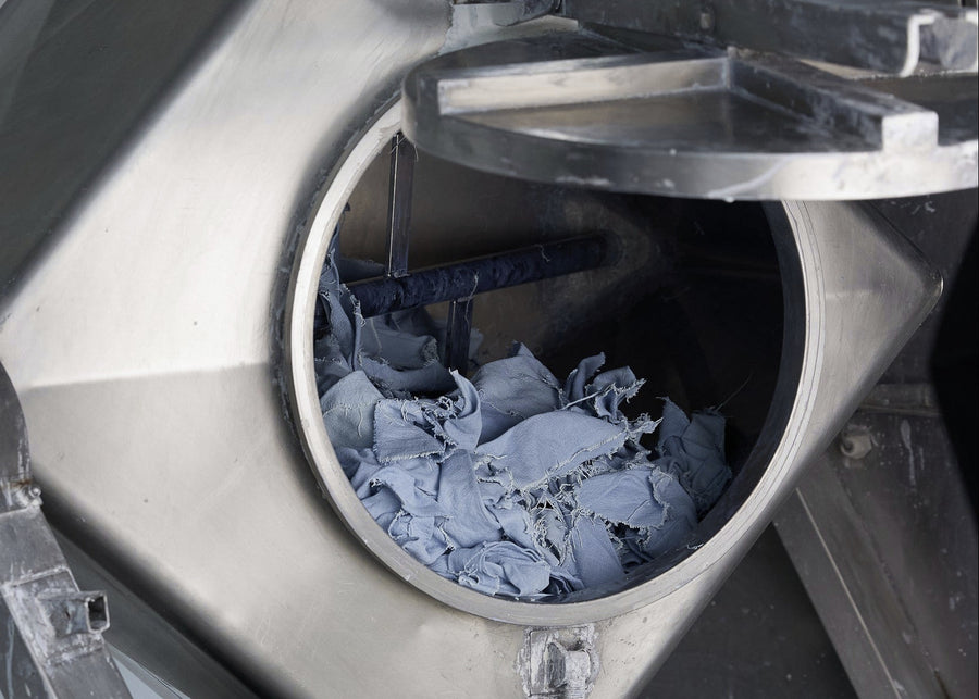 Metallic machine with a circular opening containing blue fabric.